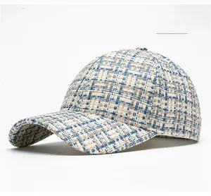 Detail of blue and beige tweed baseball cap showing premium woven fabric texture