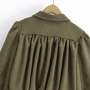 Detail view of military green suede jacket featuring pleats and a turn-down collar