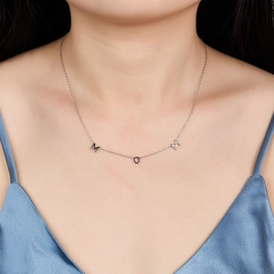 Detailed view of S925 silver MOM pendant necklace worn on neck with elegant blue satin