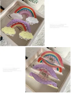 Detail of colorful rainbow hair claw clip with clouds and sturdy metal spring