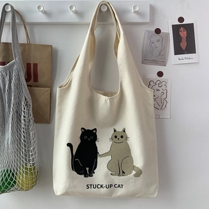 Detail of canvas tote bag featuring cute cat illustrations and artistic minimalist decor
