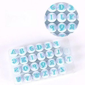 26-piece set of blue and white uppercase letter cookie stamps with spring-loaded handles