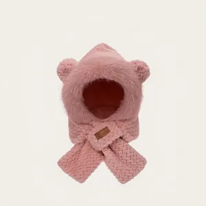 Close-up of plush pink hooded scarf featuring cute bear ears and a premium leather tag
