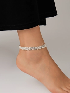 Close-up of a sparkling silver rhinestone anklet on ankle with elegant crystal details