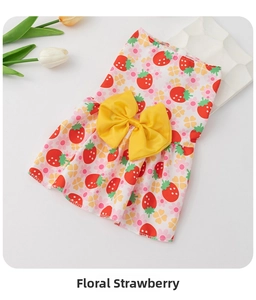 Detail of pet summer dress featuring strawberry print and large yellow bow decoration