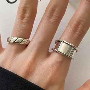 Detailed macro view of retro 925 sterling silver rings with twisted rope and diagonal textures