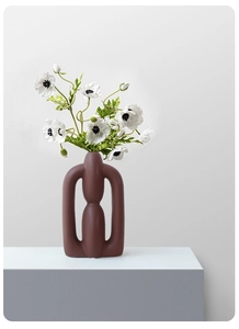 Detailed macro view of the matte textured finish and hollow geometric ceramic vase