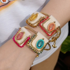 Detail of four handmade religious bracelets with Virgin Mary medals and woven straps
