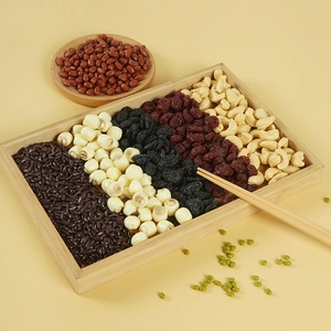 Detailed macro view of artificial assorted grains and dried fruits on a bamboo tray