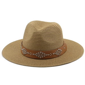 Macro view of woven straw hat featuring brown leather band with silver metal rivets