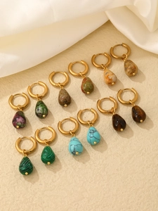 Collection of teardrop natural stone hoop earrings in various colors on silk background