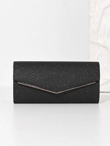 Close-up of black glitter evening bag with elegant rose gold metallic trim