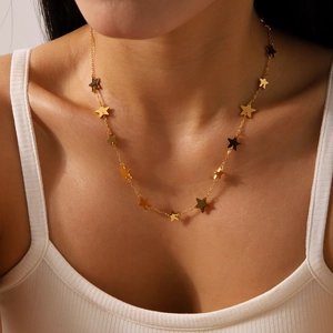 Gold plated stainless steel necklace with multi-star pendants on model's neck