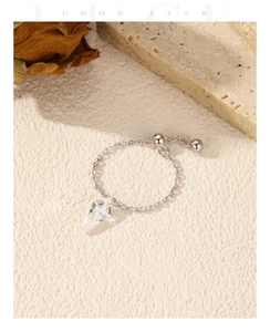 Detailed macro of a S925 silver adjustable chain ring with sparkling crystal pendant