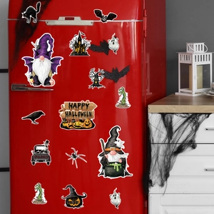 Detail of Halloween gnome and pumpkin magnets displayed on a red refrigerator surface