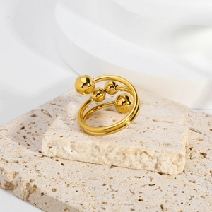 Moderno anello a spirale in acciaio al titanio dorato con perline lucide e design aperto
