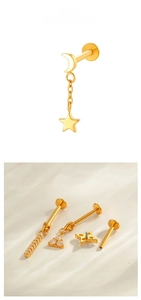 Macro view of G23 titanium labret studs featuring star and moon charms with internal threading