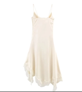 Detailed view of champagne satin dress with delicate lace trim and irregular hemline