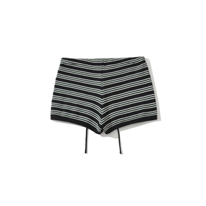 Detailed flat lay of black and white striped knitted shorts with soft textured fabric