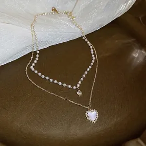 Elegant French style double-layer gold necklace featuring pearls and heart pendant