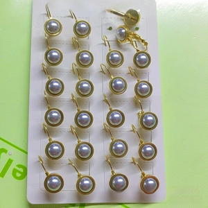 Close-up of vintage stainless steel leverback earrings with blue semi-round pearls