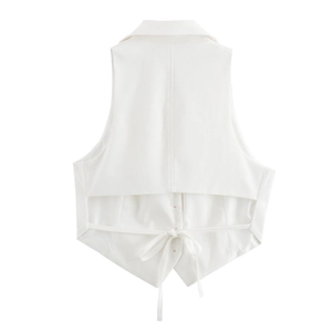 Detail of white backless vest showing hollow design and tie-waist closure details
