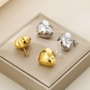Polished stainless steel heart stud earrings in gold and silver with hammered texture