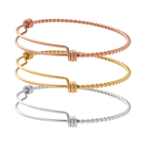Detail view of adjustable twisted rope bangles in rose gold, gold, and silver finishes