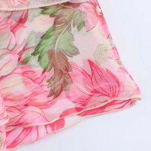 Detail of floral print chiffon blouse showing layered fabric texture and fine stitching
