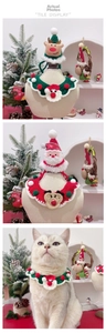 Detail of hand-knitted pet Christmas collar and hat set with festive reindeer motifs