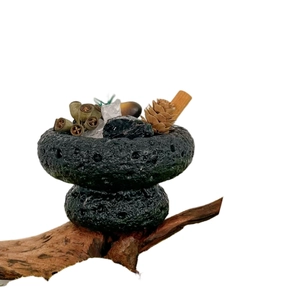 Essential oil diffuser stone gift box with crystal, pine cone and cinnamon on wood branch