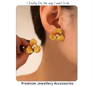 Detailed view of 18k gold plated flower earrings with pearl and zircon inlay