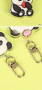Macro shot of cartoon panda keychain showing smooth laser-cut edges and silver metal D-ring