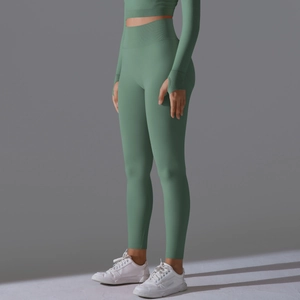 Detail of high-waist seamless leggings with knit texture and thumbhole sleeve top