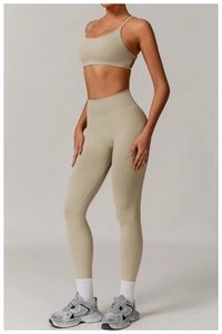 Side view of beige high waist seamless yoga set featuring cross-back sports bra and leggings