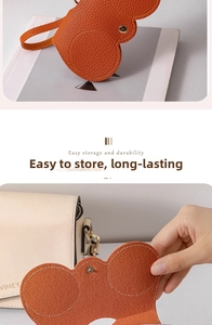 Macro detail of orange pebble grain PU leather pouch with metal snap button closure