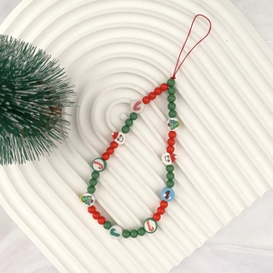 Christmas beaded phone charm with Santa and tree charms in red and green festive colors