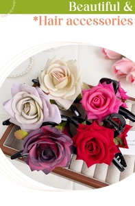 Detail view of five elegant artificial rose hair clips in vibrant colors on a wooden tray