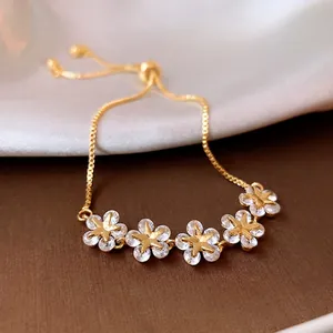Gold-plated floral star bracelet with white zircon petals and adjustable slider clasp