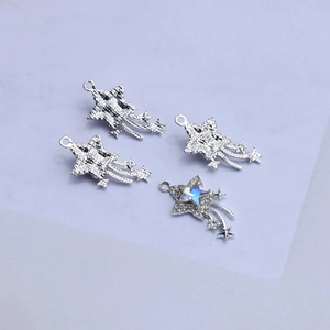 Close-up of silver star pendants with sparkling blue rhinestones for DIY jewelry making
