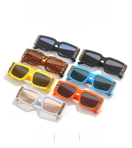 Detail view of square fashion sunglasses with colorful rhinestones in multiple colors