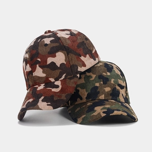 Detailed texture of camouflage corduroy baseball caps in tan and olive green colors