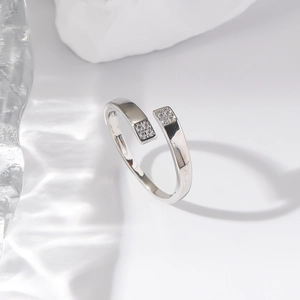Polished silver adjustable open ring with sparkling zircon squares on a water background