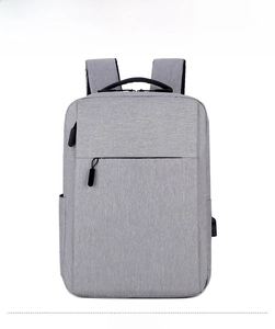 Front view of grey laptop backpack with USB charging port and splash-proof fabric