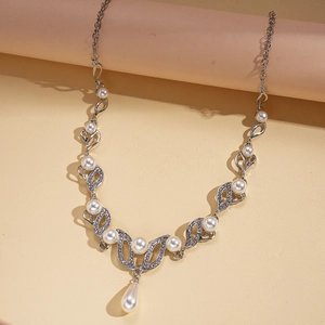 Close-up of silver-tone teardrop pearl necklace with leaf-shaped zircon pendant