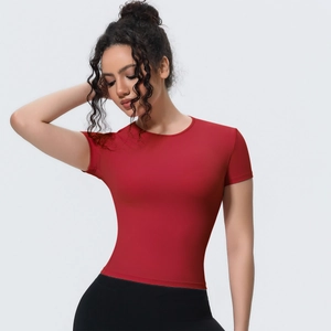 Detail of red slim-fit yoga T-shirt showing round neck and breathable fabric texture