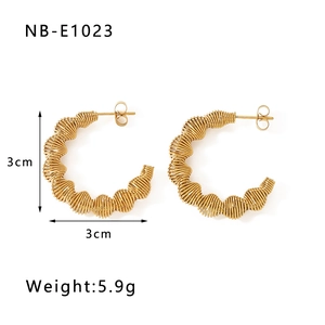 Detail of 3cm 18k gold plated C-shaped earrings with twisted texture and butterfly back