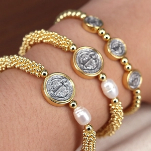 Adjustable golden beaded bracelet set with baroque pearls and religious saint medals