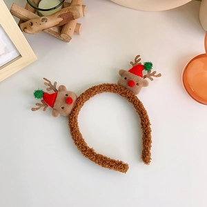 Detail view of brown reindeer Christmas headband with cute Santa hats on a festive table
