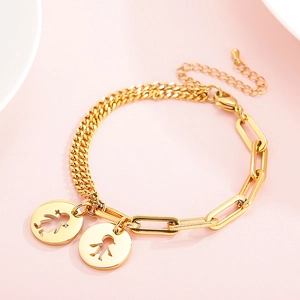 Detail of gold paperclip and curb chain bracelet with hollow boy and girl pendants